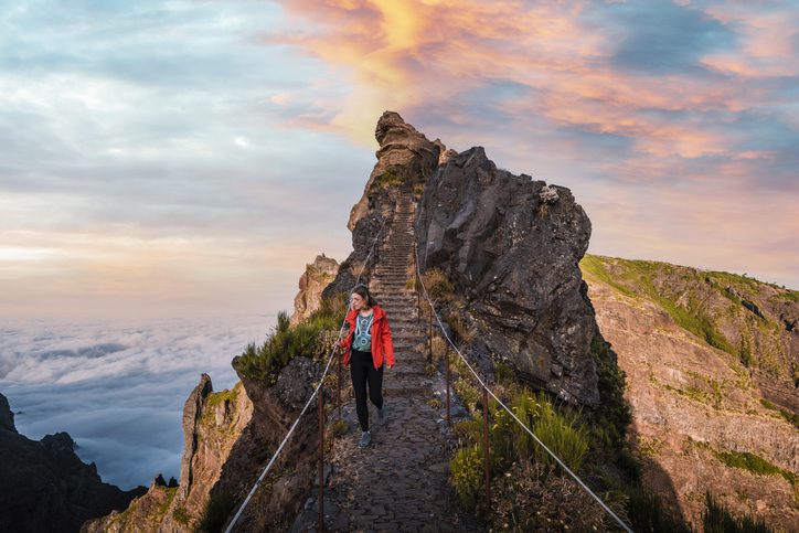 Young woman walking on a scenic mountain trail