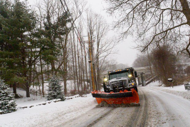 A snowplow removes the snow on Maple Street in Brattleboro, Vt., while the snow falls on Saturday. (Kristopher Radder /The Brattleboro Reformer via AP)