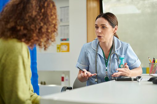 female nurse explaining to patient