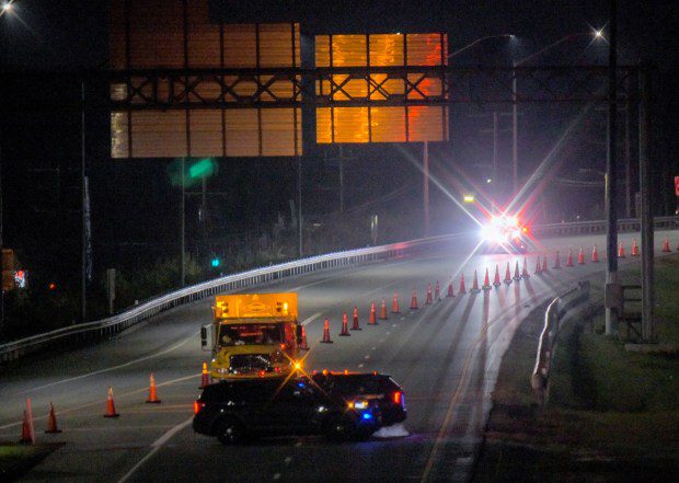 Emergency crews head to the exit off of the Baltimore Beltway I-695 from the closed off section where the Francis Scott Key Bridge lies in ruins in the waters of the Patapsco River after a container ship collided with the structure overnight. (Karl Merton Ferron/Staff)