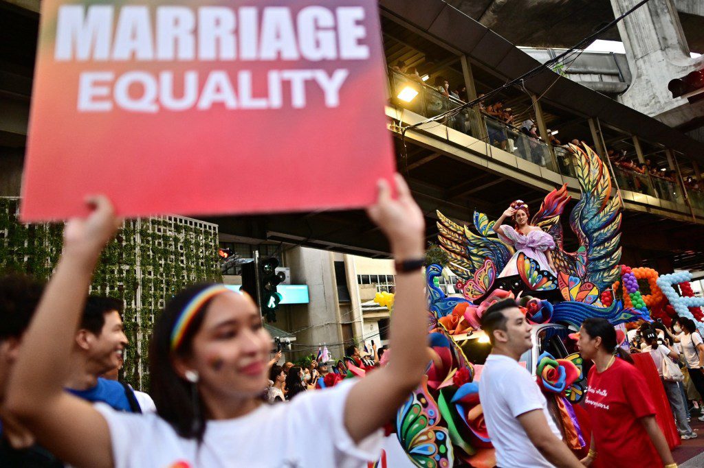 A member of the LGBTQIA+ community holds a placard calling for marriage equality during a pride march in Bangkok on June 4, 2023.