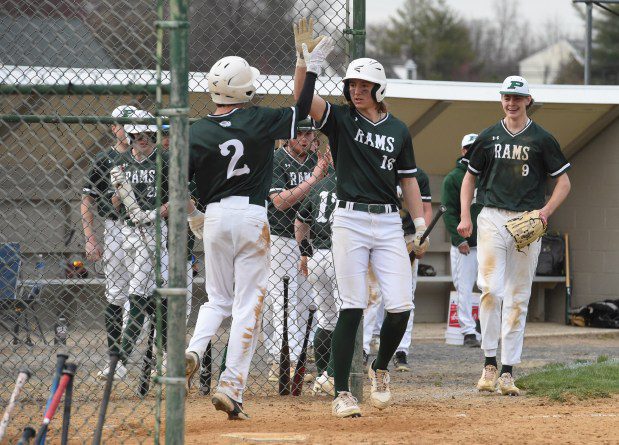 Pennridge's Owen Gruver, 2, gets a high five from Noah Keating 16, after Gruver scored a run in the top of the sixth inning to give the Rams a 3-2 lead over Souderton in their game on Tuesday, March 26, 2024. (Mike Cabrey/MediaNews Group)