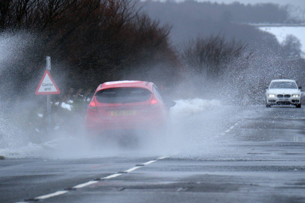 Cars drive through the snowy conditions on Dartmoor. Snow has fallen in parts of south-west England and Wales. Forecasters say an area of rain, sleet and hill snow is moving north across the UK as holidaymakers prepare to embark on Easter getaways. Picture date: Thursday March 28, 2024. PA Photo. Photo credit should read: Matt Keeble/PA Wire