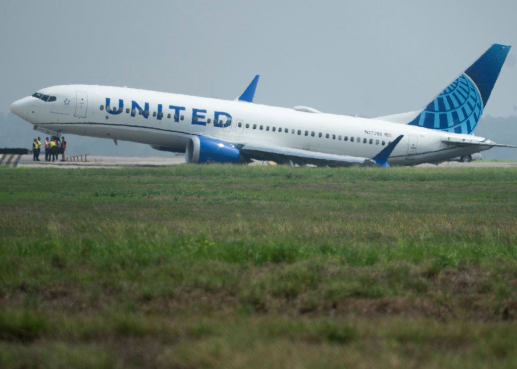 A United Airlines jet sits in a grassy area after leaving the taxiway Friday, March 8, 2024, at George Bush Intercontinental Airport in Houston. No passenger or crew injuries have been reported, according to a United Airlines spokesperson. (Jason Fochtman/Houston Chronicle via AP)