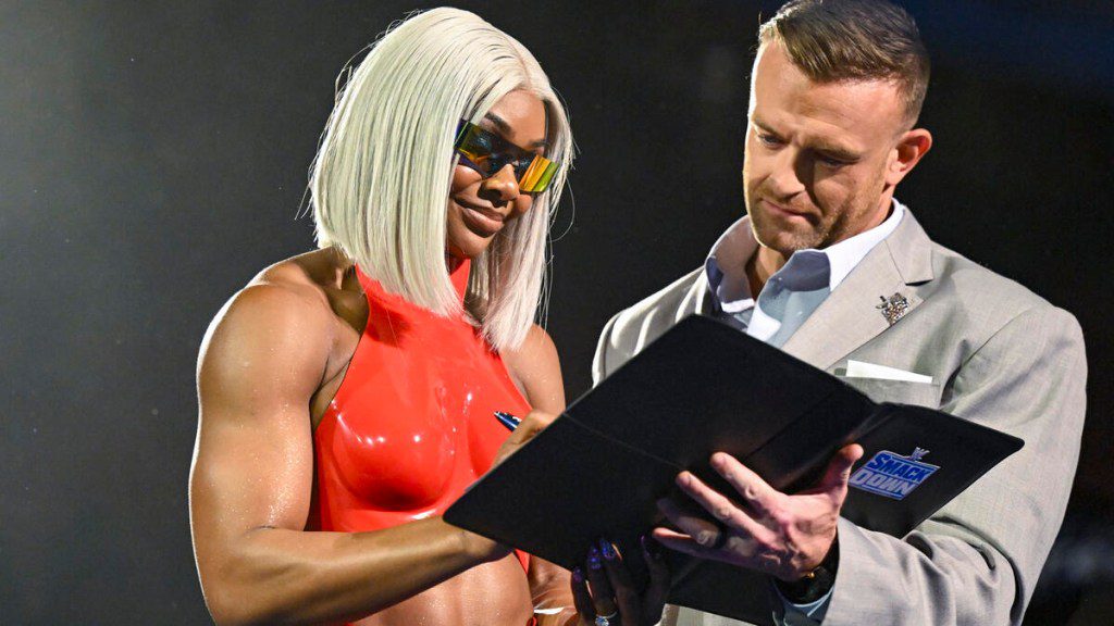 WWE superstar Jade Cargill signs with SmackDown as general manager Nick Aldis looks on