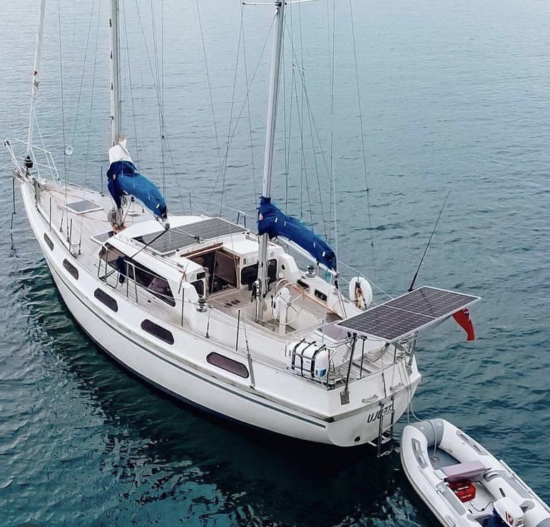 Their boat with the dingy. GRENADA, CARIBBEAN: THIS GEN-ZED couple have revealed how they turned their backs on the UK in favour of life in the open sea on a yacht that cost them just ??48K ??? and you can too. Youtube Creators Zach Seward (26) from Hampshire, UK and Becka Eva (26) from Surrey, UK left their humdrum lives in England as an Environmental and Sustainability Business Partner and Social Researcher for a life full of adventures at sea where they have clocked up over 5,000 miles and visited France, Spain, Portugal, Canary Islands, Cape Verde, Antigua Lesser Antilles, ending up in their present location of Grenada in the Caribbean. In March 2022, the couple decided it was finally time to start their dream of living full-time on a sailboat and bought a 40ft 1987 Colvic Victor Ketch for ??38K in Plymouth, UK. This was to replace the university student house they were recently staying with a friend in. Becka and Zach had been eyeing-up sailboats for some time and had been saving for over three years for the opportunity to arise for them to set-sail on their dream life, when in 2022 after the COVID-19 pandemic hit the UK, they realised it was their perfect opportunity. During the COVID-19 lockdown in the UK in March 2022, Becka and Zach were confined to Backa???s room in her University house share. During this time, the pair were itching to get out and see the world, which prompted them to finally take the leap and buy a boat to set sail on their new path. Once they had decided that the 1987 Colvic Victor ketch was the boat for them, they spent nearly ??10K restoring and renovating the boat before they started sailing. Although the boat was as far as they were concerned, nearly perfect, they had decided to add a few more touches before they set sail. They added safety gear, new batteries, redid the electrics, added solar panels and got the boat fully off grid, added a new VHF radio, another antenna as redundancy, took the mizzen mast down to inspect, replaced sea cocks and skin fittings, added anodes, and antifouled. The whole restoration took around six months in total and around ??10K, but was well worth it to Becka and Zach as they began their sailing journey a week after they were completely finished in September 2022. Becka and Zach have since sailed over 5,000-nautical miles and have lived on their sailboat full-time since starting their journey, bar the odd stop to avoid dangerous stormy weather. Both have thoroughly loved their experience sailing full-time as it has added so much freedom and independence to their lives that they felt was lacking, especially throughout the pandemic lockdown. ???During the first lockdown in March 2020, Zach and I were shut in a room in my uni house together, and we were itching to see the world,??? Becka said. ???We didn???t want to take a plane everywhere and although van life is really cool, we really wanted to go to small remote islands, which would have been hard to get to on foot, let alone bringing a van to. ???We were looking at much older boats with far more issues and this one was far out of our budget initially (we ended up getting a really good deal). ???So after a friend sent us a link on Facebook with ???this would be perfect for you???, we decided to go to see her just to window-shop and daydream about what we would love to buy one day, and she was incredibly perfect. ???The moment we stepped on board, we knew somehow, we would make this our home.??? Becka and Zach spent the next six months restoring the boat and making it perfect for their new life on the water. ???She didn???t need a lot of work doing to her when we first got her, but there was zero safety gear on board, so the first job was to add all the safety gear,??? she said. ???We then added new batteries, redid the electrics, added solar panels and got her fully off grid. ???We added a new VHF radio, another antenna as redundancy, we took our mizzen mast down to inspect, hauled her out and replaced sea cocks and skin fittings (the points where water enters or leaves the boat), added anodes, antifouled, the list goes on. ???We bought her in March 2022 and finished all the jobs we wanted to a week before leaving in September 2022.??? Becka and Zach threw themselves into sailing life with little boating experience, although they both crewed on a boat going from Swansea to Cardiff four months before they sailed on their own boat, and achieved their Day Skippers qualification, which gave them some knowledge about sailing life before they started their own. ???We had both dingy sailed since we were young (Zach more than I) but in terms of big boats, we didn???t have too much experience,??? she said. ???We crewed on a boat from Swansea to Cardiff about four months before we bought our boat, and did our Day Skippers (a week long qualification), but that was about it, until we hopped on our