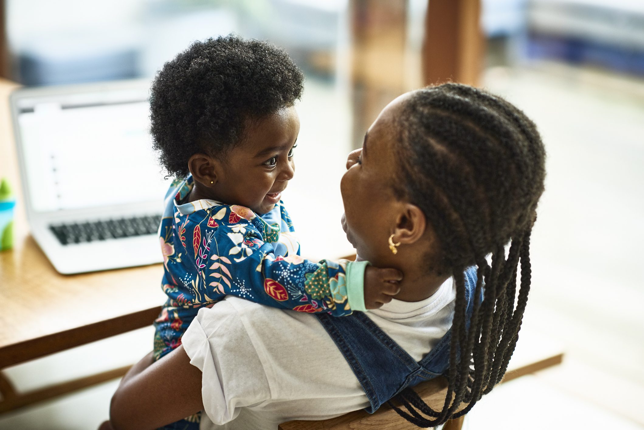 Woman sitting with baby son in her arms