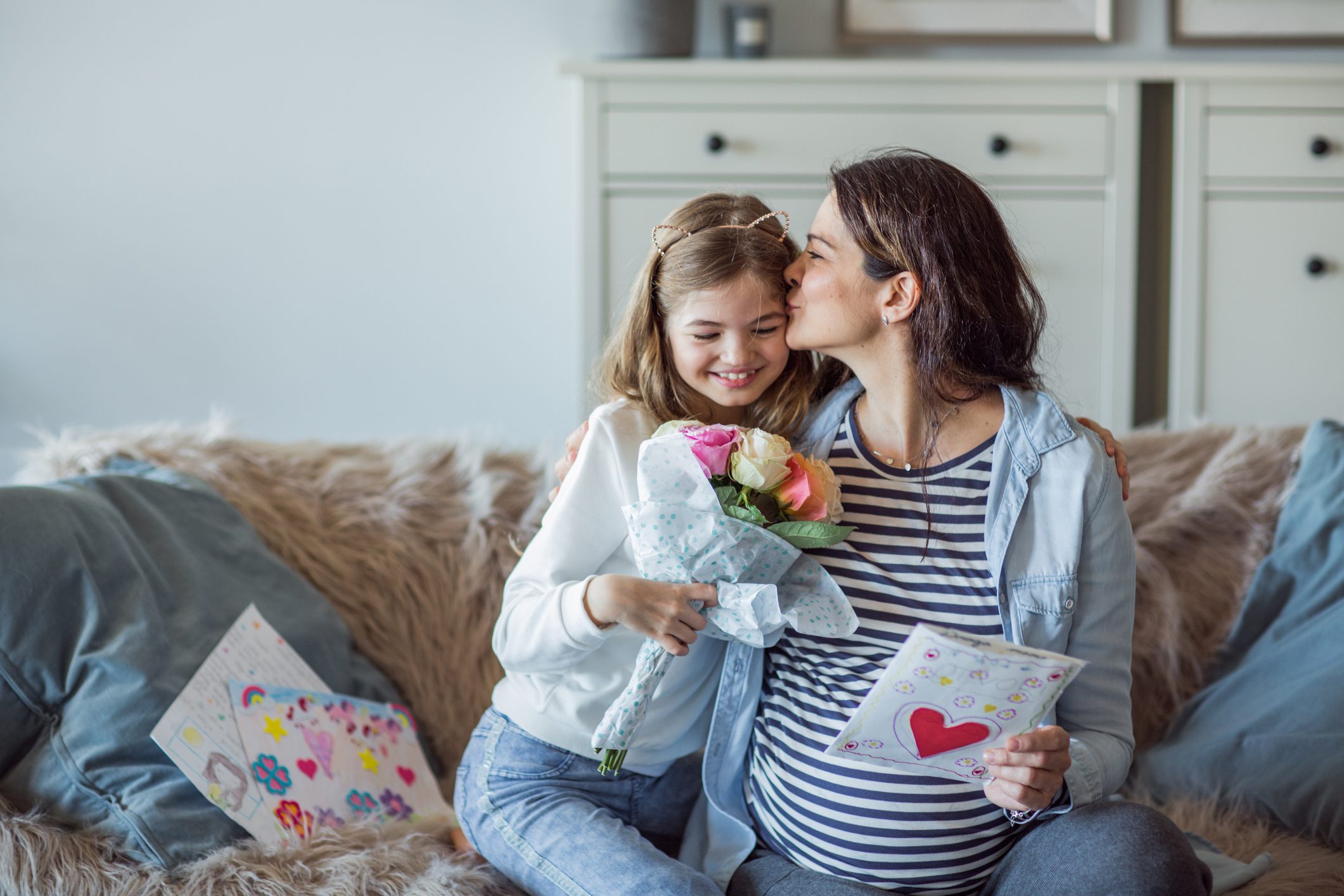 mum kisses daughter on forehead