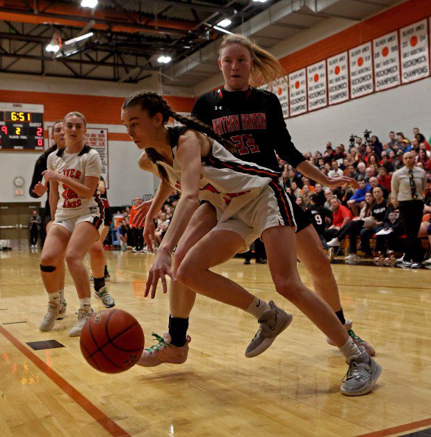 Annie Reilly of Oliver Ames drives by Whitman-Hanson's Taryn Leonard during girls basketball action Friday. (Staff Photo/Stuart Cahill/Boston Herald)