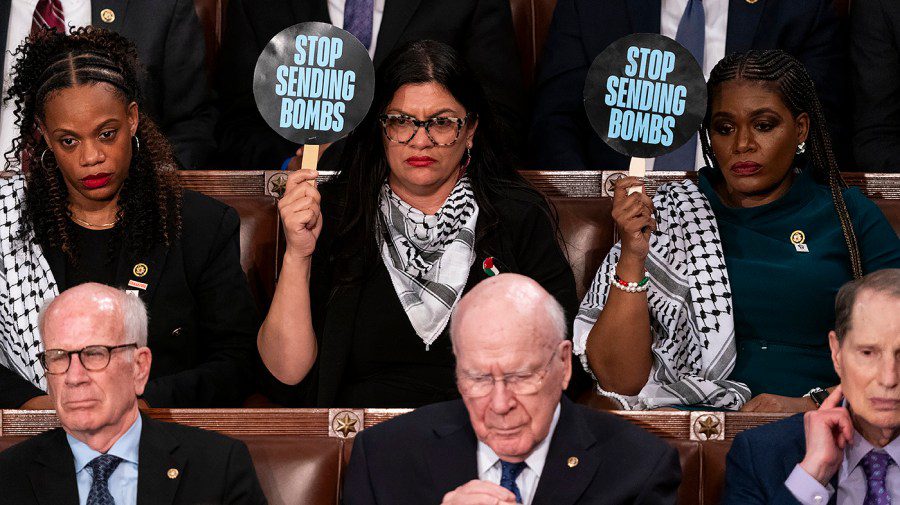 Reps. Rashida Tlaib (D-Mich.) and Cori Bush (D-Mo.) hold up ‘stop sending bombs’ signs