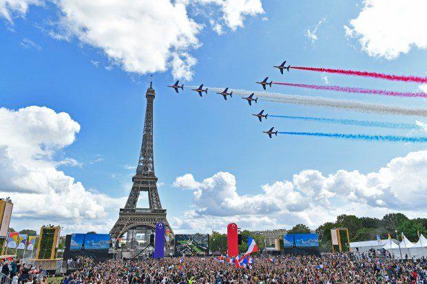 Planes do a colorful flyover of the Eiffel Tower.