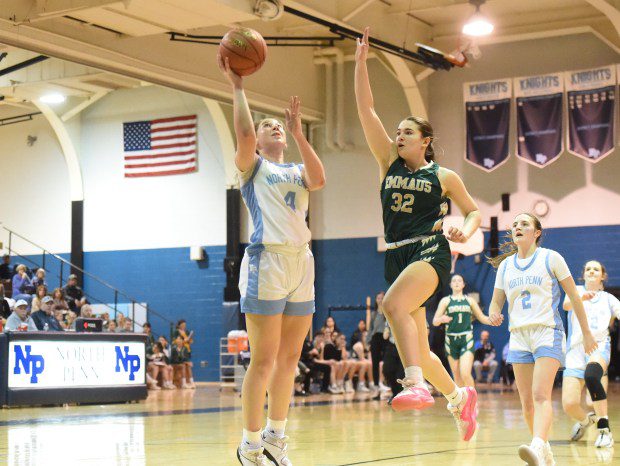 North Penn's Caleigh Sperling, 4, goes up for a shot as Emmaus' Sofie Laird contests during their PIAA-6A first round game on Friday, March 8, 2024. Sperling scored and was fouled, hitting the free throw to complete the 3-point play. (Mike Cabrey/MediaNews Group)