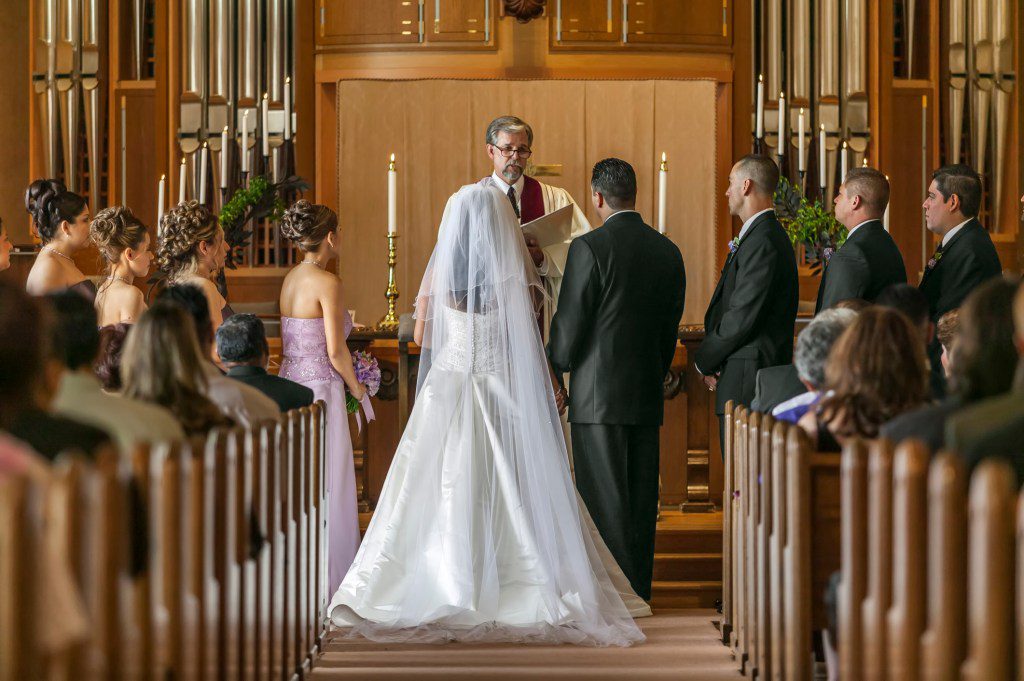 Bride and groom standing at altar during wedding ceremony