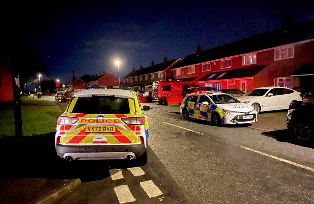 Police vehicles at the corner of Tetbury Drive and Haresfield Close in Warndon, Worcester. March 2, 2024. Release date ? March 3, 2024. See SWNS story SWLSmurder. A murder investigation has been launched following the death of a woman in Worcester. A second woman is also in hospital fighting for her life after an incident on Haresfield Close in Warndon. A man aged 50 has been arrested on suspicion of murder and attempted murder. A large emergency service presence was seen on the residential road last night (Saturday) following the death of a 58-year-old woman. The second woman, aged 39, was found with life-threatening injuries. A witness said they saw a person being treated on the ground before an ambulance left the scene on blue lights. There were a large number of police vehicles, ambulances and a critical care team at the scene.