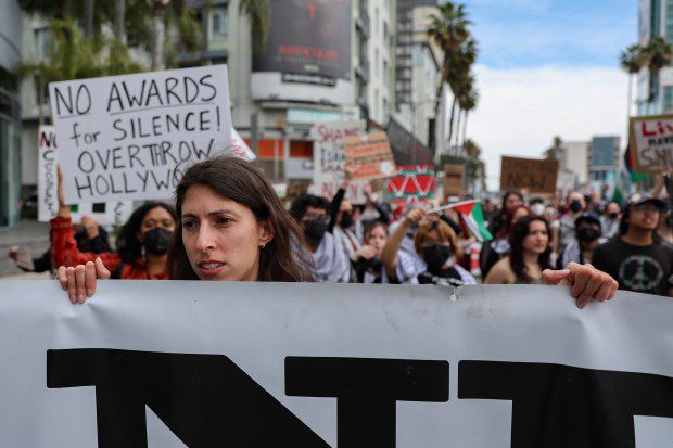 Protesters gather during a demonstration in support of Palestinians calling for a ceasefire in Gaza as the 96th Academy Awards Oscars ceremony is held nearby, Sunday, March 10, 2024, in the Hollywood section of Los Angeles. (AP Photo/Etienne Laurent)