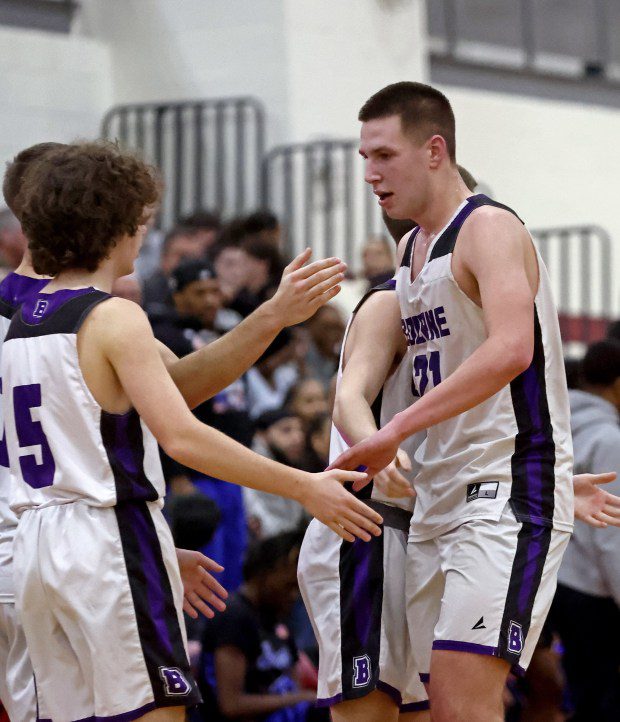 Bourne's Mike Dankert, right, is congratulated for his bucket during a 71-60 win over Burke in a state semifinal Tuesday night. (Staff Photo/Stuart Cahill/Boston Herald)