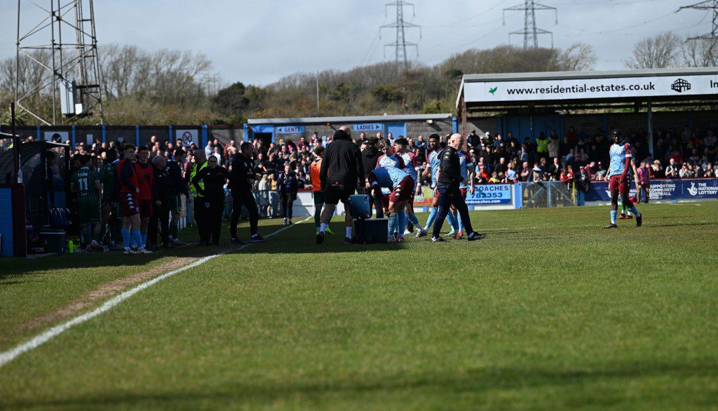 Mandatory Credit: Photo by MAT MINGO/PPA/Shutterstock (14413677ac) Player walking before Air Ambulance had to land for Medical Emergency during the National League South match between Weymouth and Yeovil Town at Bob Lucas Stadium on 01st April 2024 in Weymouth, England - Photo by Mat Mingo/PPAUK Weymouth v Yeovil Town - Bob Lucas Stadium, Weymouth, UK - 01 Apr 2024