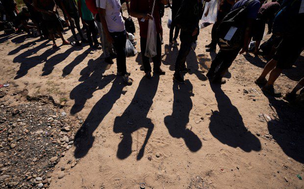 FILE - Migrants wait to be processed by the U.S. Customs and Border Patrol after they crossed the Rio Grande and entered the U.S. from Mexico, Oct. 19, 2023, in Eagle Pass, Texas. Donald Trump's anti-immigrant rhetoric appears to be making inroads even among some Democrats, a worrying sign for President Joe Biden. (AP Photo/Eric Gay, File)