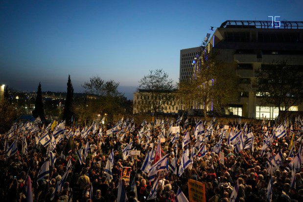 People take part in a protest against Israeli Prime Minister Benjamin Netanyahu's government and call for the release of hostages held in the Gaza Strip by the Hamas militant group outside of the Knesset, Israel's parliament, in Jerusalem, Sunday, March 31, 2024. Tens of thousands of Israelis gathered outside the parliament building in Jerusalem on Sunday, calling on the government to reach a deal to free dozens of hostages held by Hamas and to hold early elections. (AP Photo/Leo Correa)