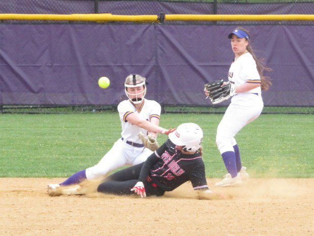 Upper Dublin's Kate Brannigan slides into second base while the ball bounces away from Upper Moreland's Melissa Torpey Thursday, April 18, 2024. (Ed Morlock/MediaNews Group)