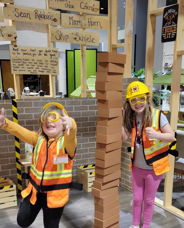 Aubrey Hill, left, and Hailey Hill, right, play in the construction play area at The Barn Yard - a Collegeville indoor play space owned by Ashleigh Hill. (Photo Courtesy Ashleigh Hill)