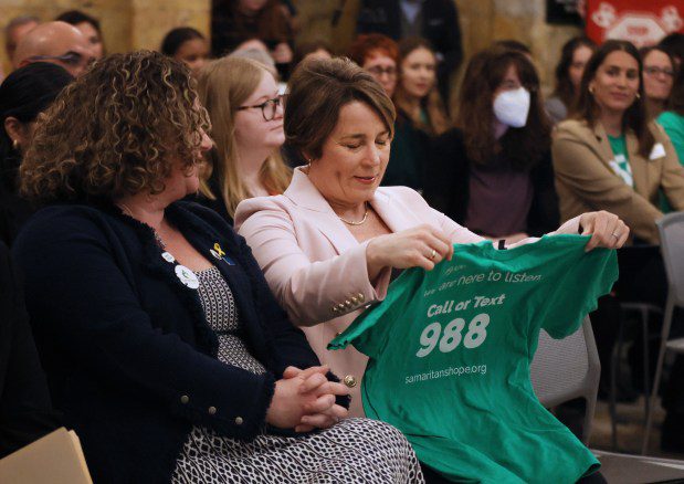 Gov. Maura Healey takes a look at a Samaritans T-shirt after speaking at the organization's 50th Anniversary event at the State House. (Nancy Lane/Boston Herald)