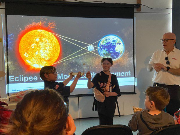 Nasa expert Donald Miller, right, invited members of the audience to help him explain different aspects of a solar eclipse. (Evan Brandt -- MediaNews Group)