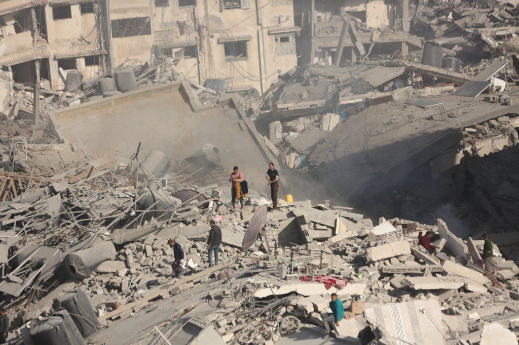 GAZA - APRIL 1: Palestinians gather around the burned and destroyed Al-Shifa Hospital after the Israeli attacks as Israeli forces withdrew from Al-Shifa hospital in Deir Al-Balah, Gaza on April 1, 2024. Many buildings including the Al-Shifa Hospital heavily damaged under Israeli attacks. (Photo by Dawoud Abo Alkas/Anadolu via Getty Images)