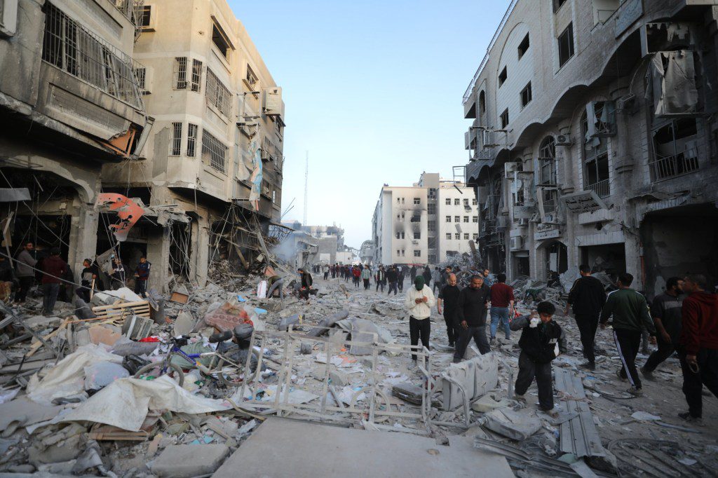 DEIR AL-BALAH, GAZA - APRIL 1: Palestinians gather around the burned and destroyed Al-Shifa Hospital after the Israeli attacks as Israeli forces withdrew from Al-Shifa hospital in Deir Al-Balah, Gaza on April 1, 2024. Many buildings including the Al-Shifa Hospital heavily damaged under Israeli attacks. (Photo by Dawoud Abo Alkas/Anadolu via Getty Images)