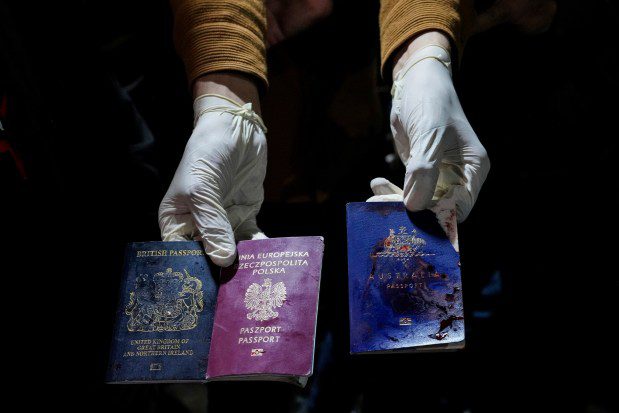 A man displays blood-stained British, Polish, and Australian passports after an Israeli airstrike, in Deir al-Balah, Gaza Strip, Monday, April 1, 2024. Gaza medical officials say an apparent Israeli airstrike killed four international aid workers with the World Central Kitchen charity and their Palestinian driver after they helped deliver food and other supplies to northern Gaza that had arrived hours earlier by ship. (AP Photo/Abdel Kareem Hana)