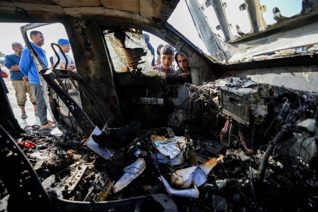 People inspect the site where World Central Kitchen workers were killed in Deir al-Balah, Gaza Strip, Tuesday, April 2, 2024. World Central Kitchen, an aid group, says an Israeli strike that hit its workers in Gaza killed at least seven people, including several foreigners. (AP Photo/Abdel Kareem Hana)