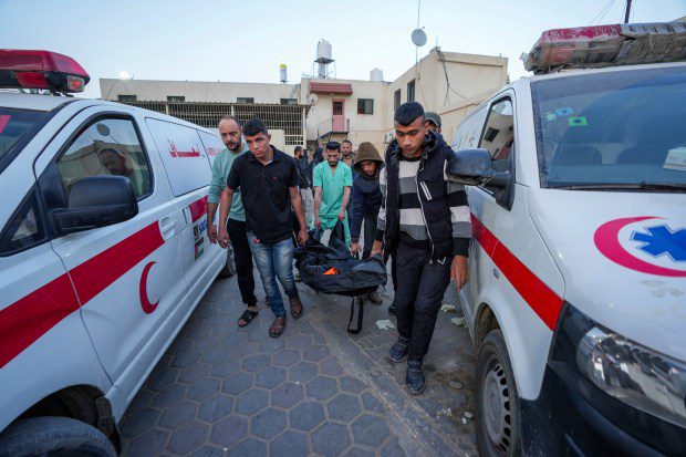 Palestinians carry the body of a World Central Kitchen worker at Al Aqsa hospital in Deir al-Balah, Gaza Strip, Tuesday, April 2, 2024. World Central Kitchen, an aid group, says an Israeli strike that hit its workers in Gaza killed at least seven people, including several foreigners. (AP Photo/Abdel Kareem Hana)