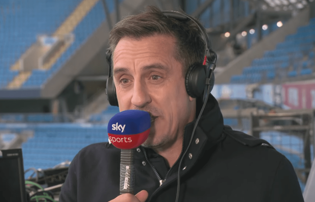 Gary Neville speaking into a microphone