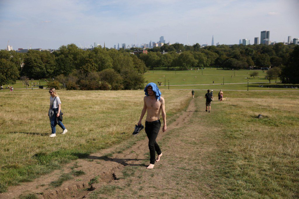 man walks up primrose hill topless