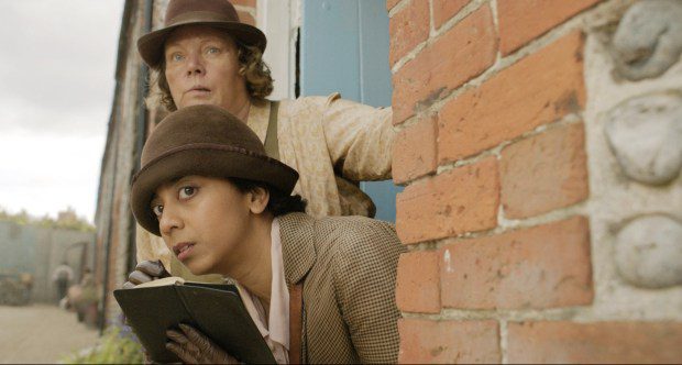 Joanna Scanlan, top, as Ann, and Anjana Vasan, as Gladys Moss, share a scene in "Wicked Little Letters." (Courtesy of Sony Pictures Classics)