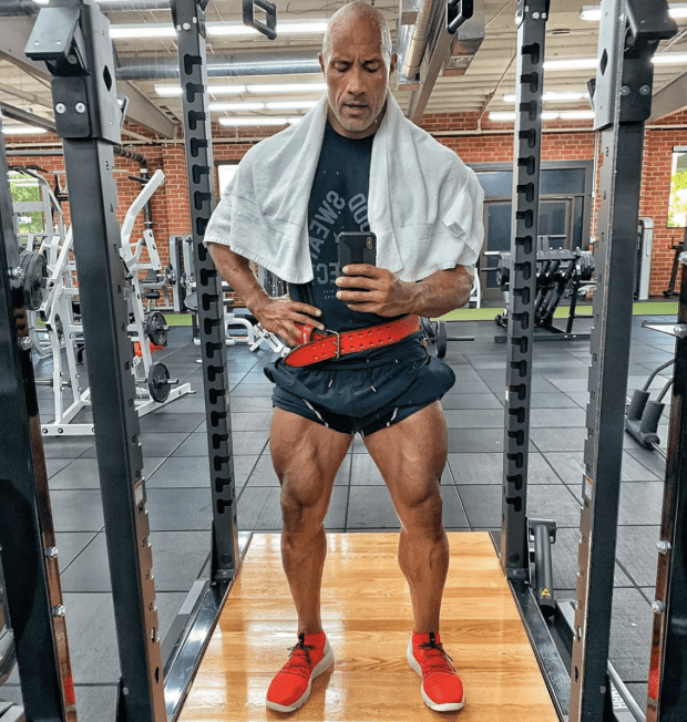 Dwayne "The Rock" Johnson, 47, takes a mid-workout mirror selfie, showing off his impressive lower body muscles while wearing his new sneakers for Under Armor. "I designed these shoes for my intense workouts. Now they're ready for yours. And now I'm ready to waddle outta the gym cuz my legs are like f*cking jello."